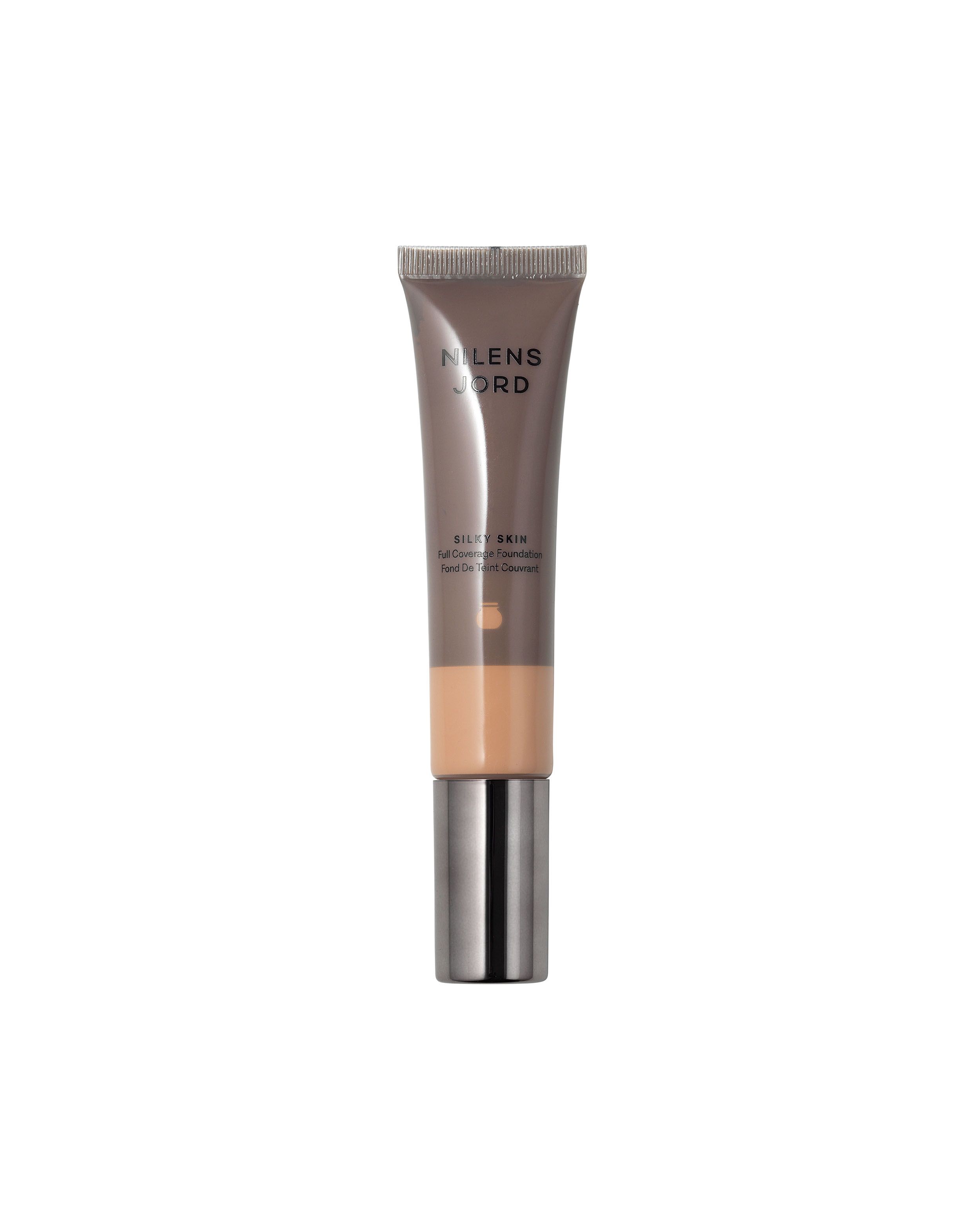 Nilens Jord Silky Skin Foundation in einem schlichten Brauntubus mit silbernem Verschluss. Mittlere Abdeckung.