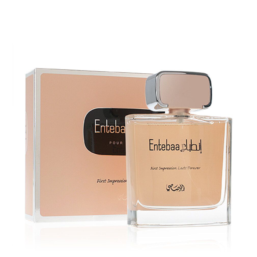 Parfümflasche und Verpackung. Flasche mit rosafarbenem Verschluss, goldfarbenem Inhalt und arabischer Schrift. Verpackung in Rosa mit schwarzem Label.