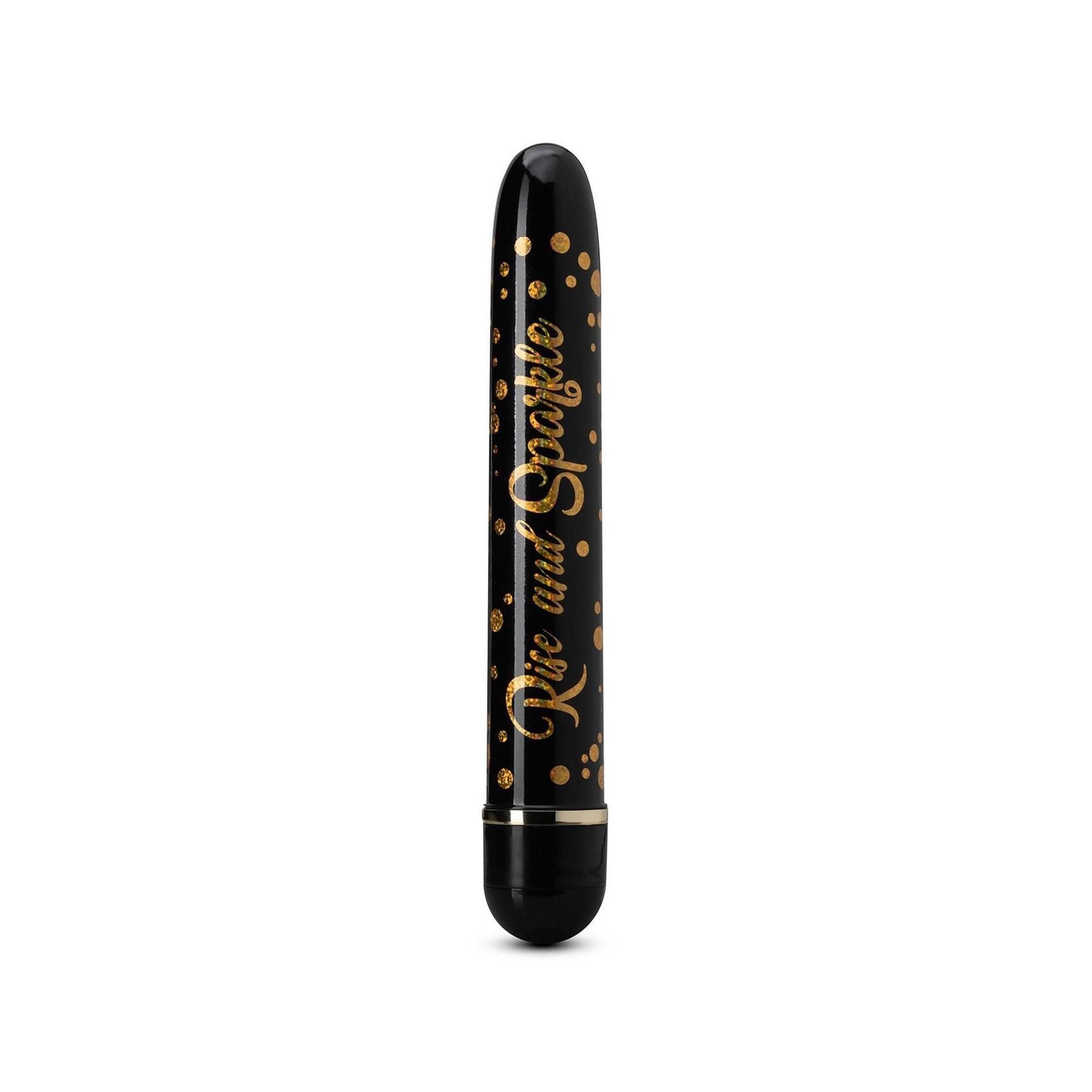 Schwarzer Vibrator mit goldenen Punkten. Aufschrift 'Rise and Sparkle'. Zylindrische Form.