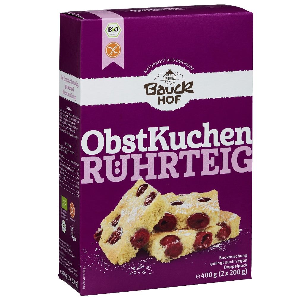 Verpackung von Obstkuchen Backmischung glutenfrei. Lila Karton mit Logo, Produktname und Kuchenstück-Abbildung. Bio-Siegel und glutenfrei-Symbol.