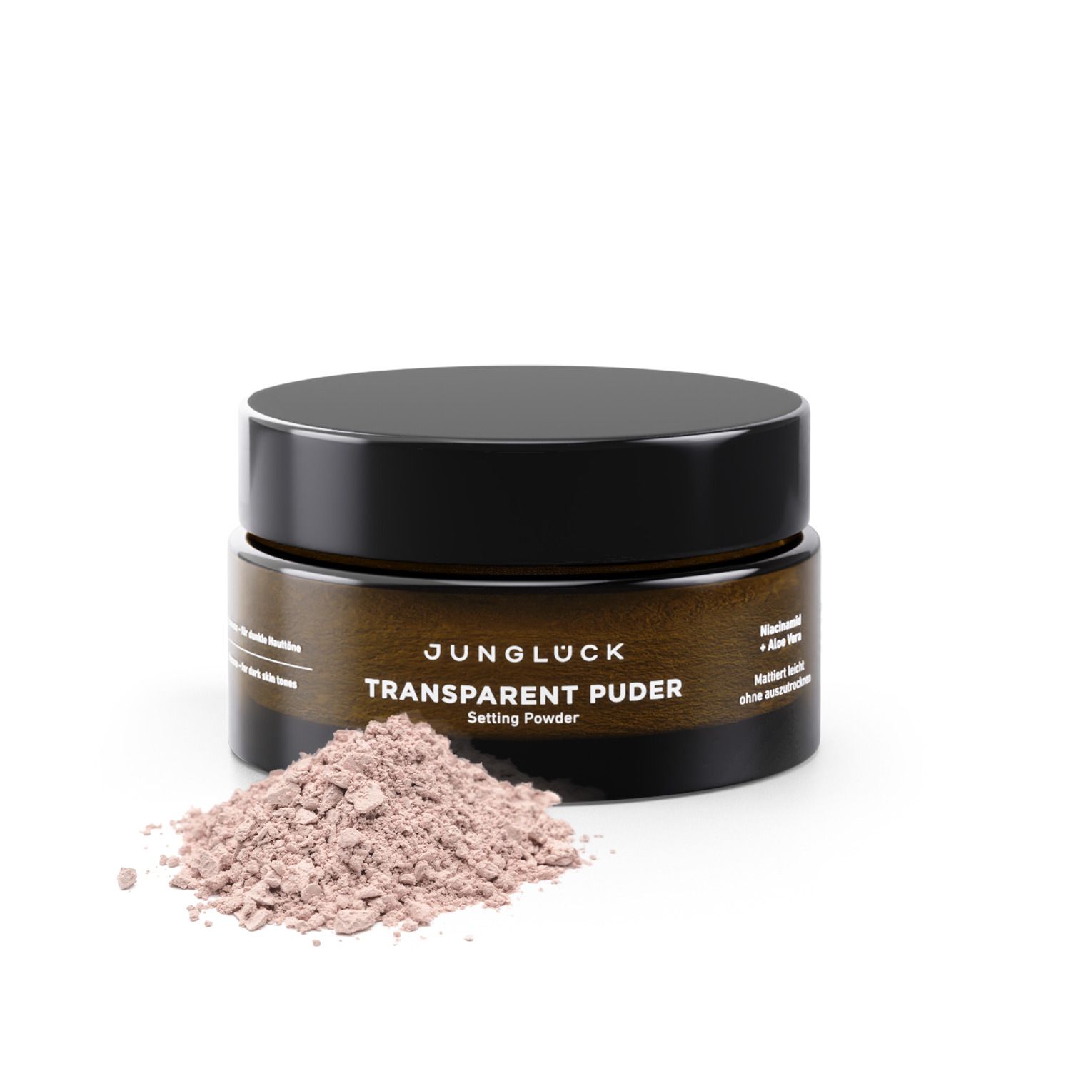 Dose mit JUNGLÜCK Transparent Puder. Braune Dose mit schwarzem Deckel. Puderhaufen daneben.