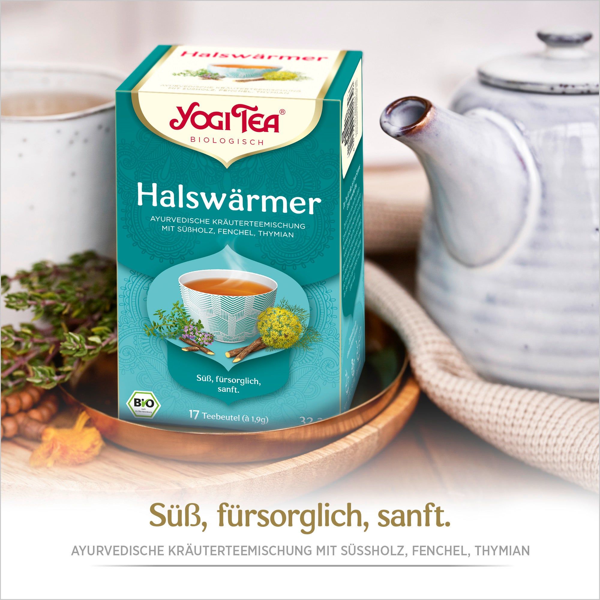 Yogi Tea Halswärmer Bio Kräutertee-Verpackung. Türkis-weiße Schachtel mit Logo und Produktbezeichnung. 17 Teebeutel. Bio-Siegel.