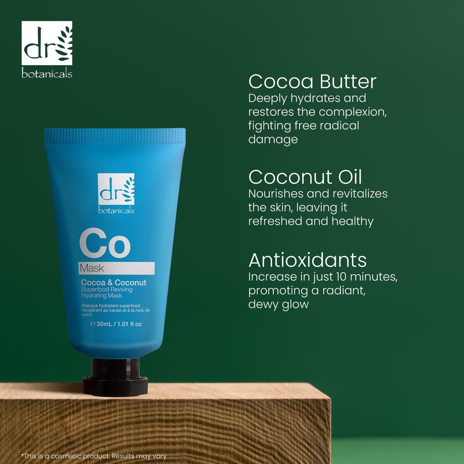 Blaue Tube auf Holzblock. Aufschrift: Co Mask, Cocoa & Coconut Superfood Reviving Hydrating Mask. Marke: dr botanicals. Text: Cocoa Butter, Coconut Oil, Antioxidants.