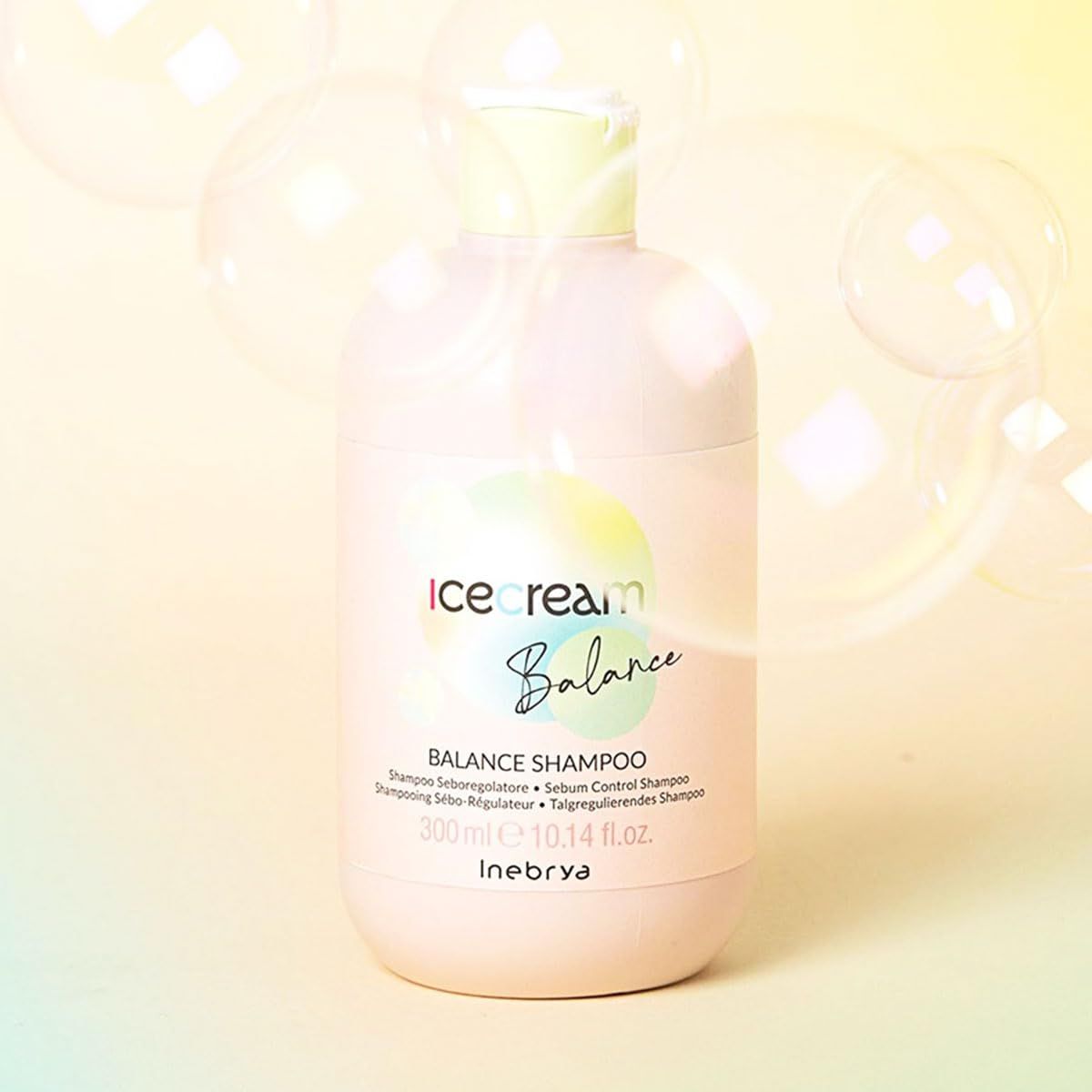 Helle rosa Flasche mit "ice cream Balance Shampoo" Aufschrift und Seifenblasen.