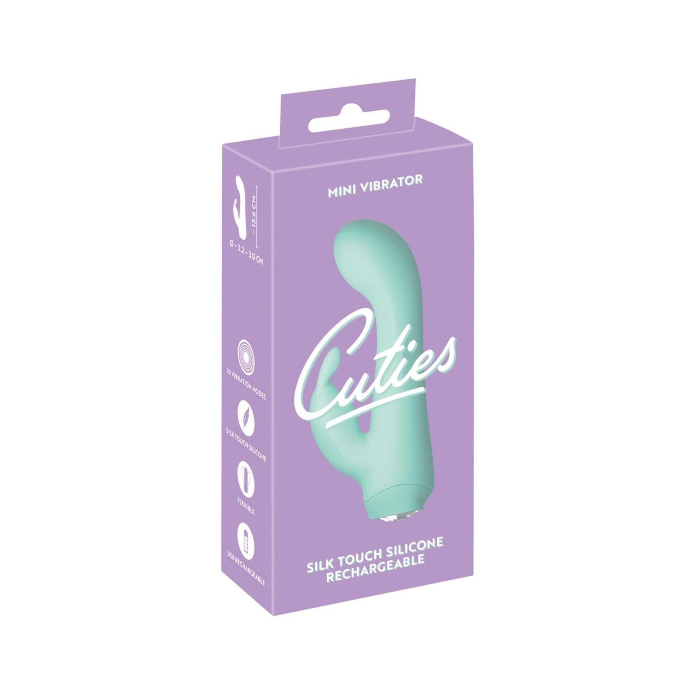 Verpackung für einen Mini-Vibrator. Lila Schachtel mit dem Produkt abgebildet. Aufschrift 'Cuties' und 'Mini Vibrator'.