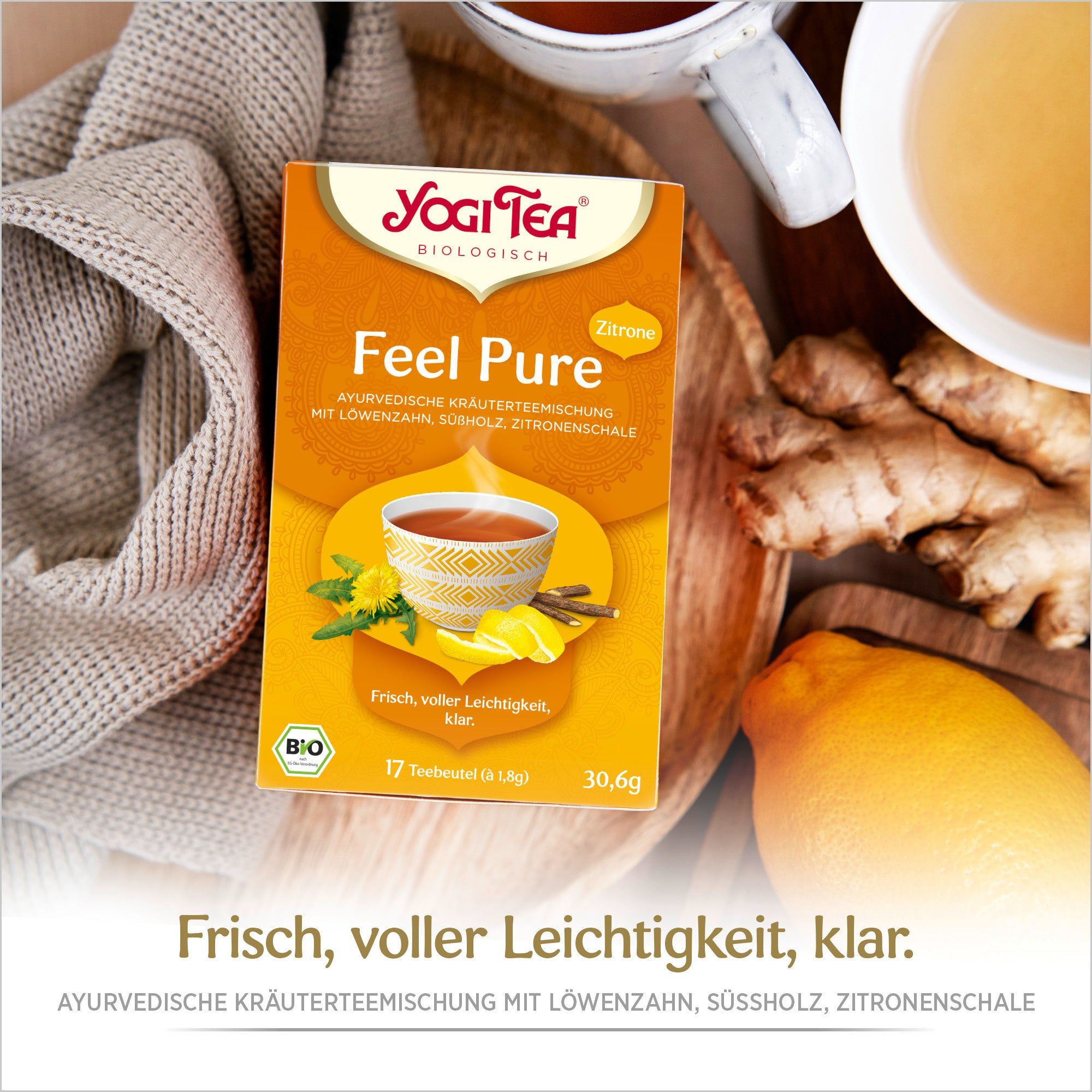 Yogi Tea - Feel Pure Packung. Aufdruck: ayurvedische Kräutermischung mit Zitrone, 17 Teebeutel, Bio-Siegel. Auf Tisch.