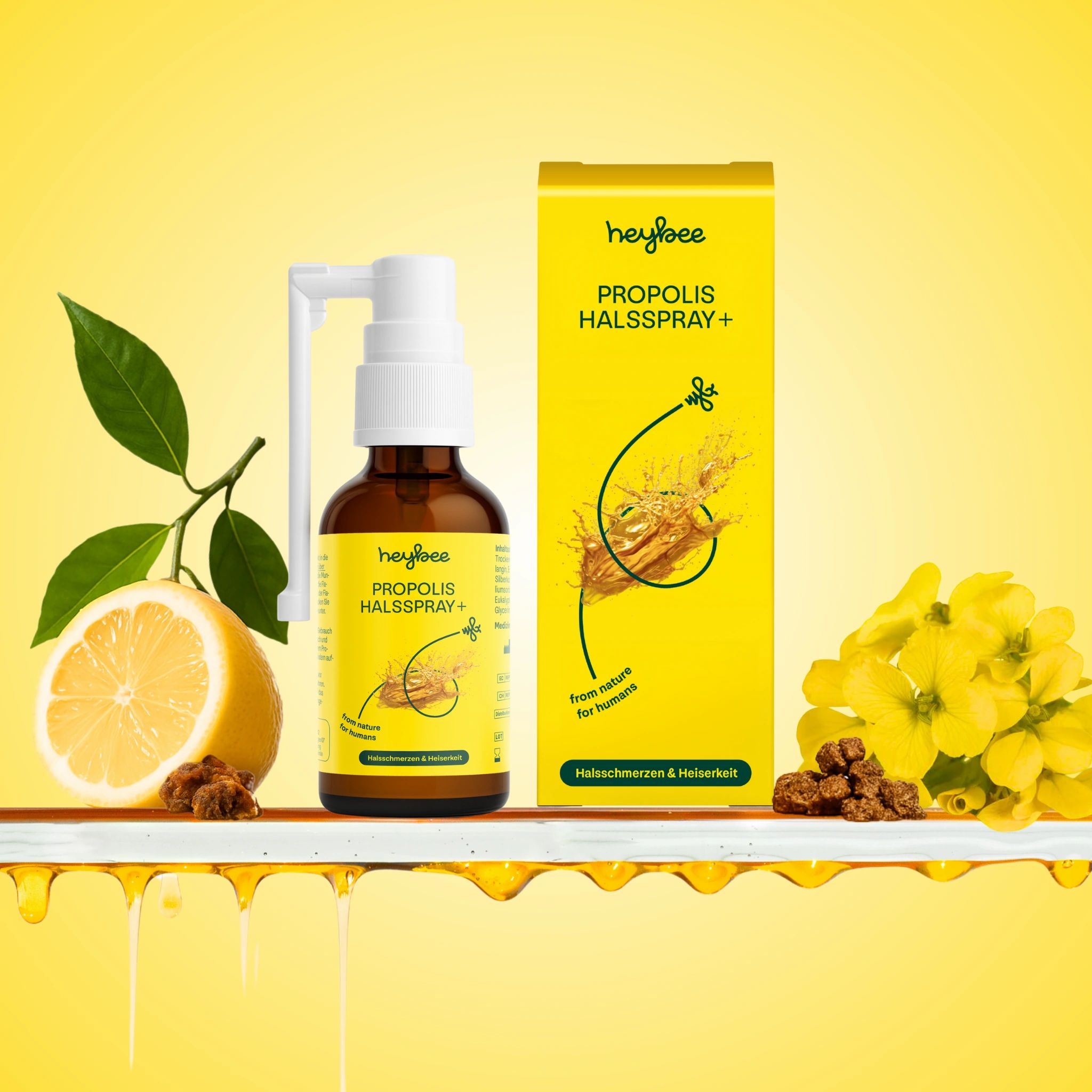 Heybee Propolis Halsspray+ Flasche und Verpackung. Mit Zitrone, Blüten und Propolis. Für Halsschmerzen und Heiserkeit.