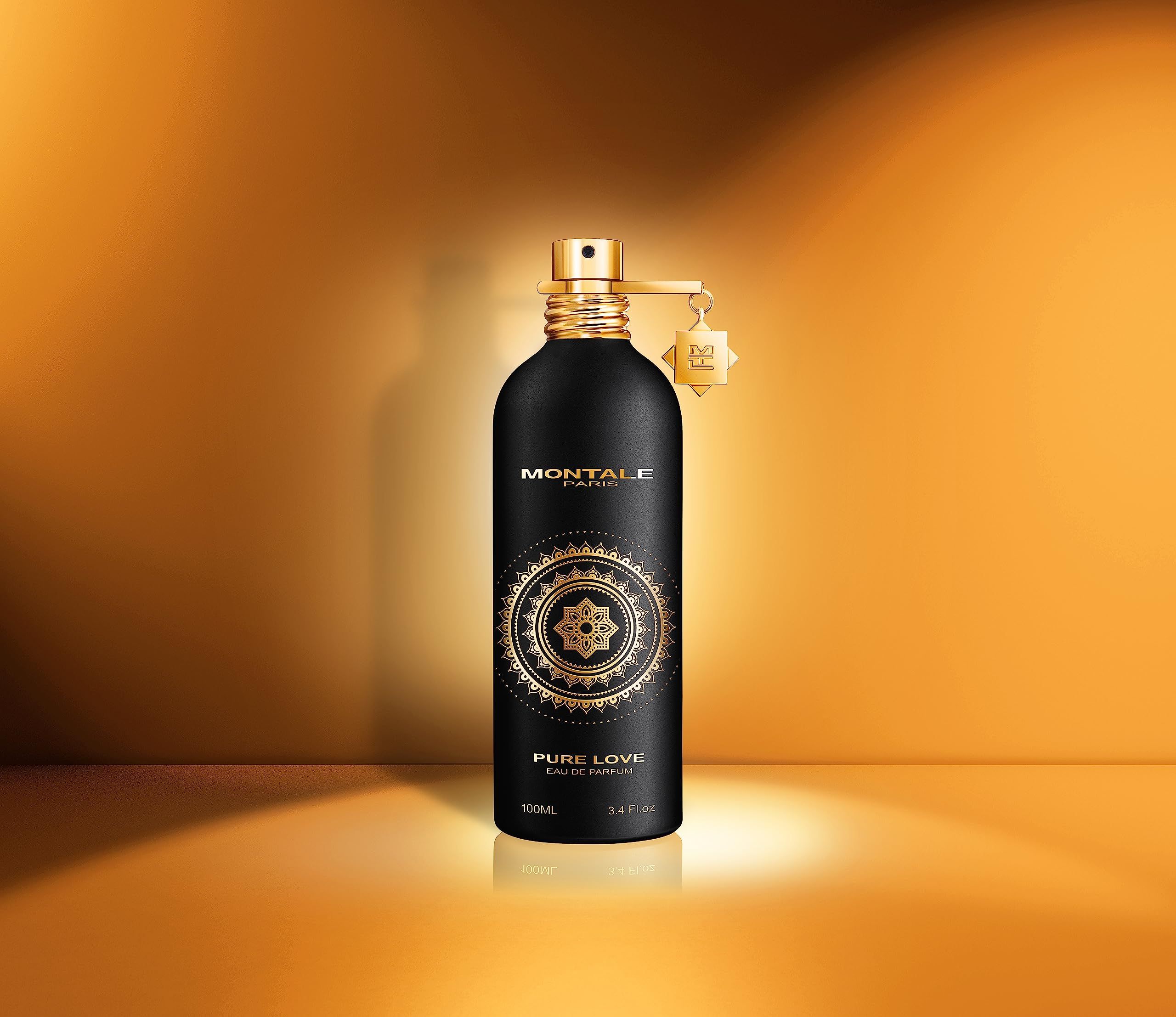 Schwarze Flasche mit goldenen Details. Aufschrift: MONTALE PARIS, PURE LOVE, Eau de Parfum. Goldener Zerstäuber.