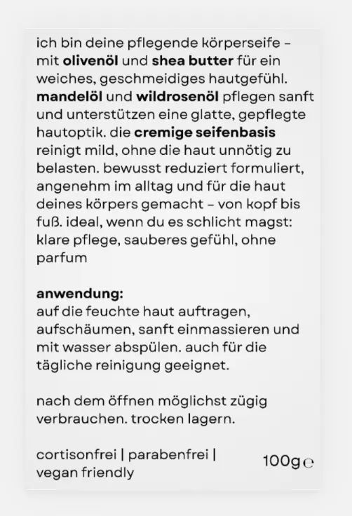 Text auf weißem Hintergrund. Aufschrift: Pflege Körperseife mit Olivenöl und Sheabutter. Vegan friendly. 100g.