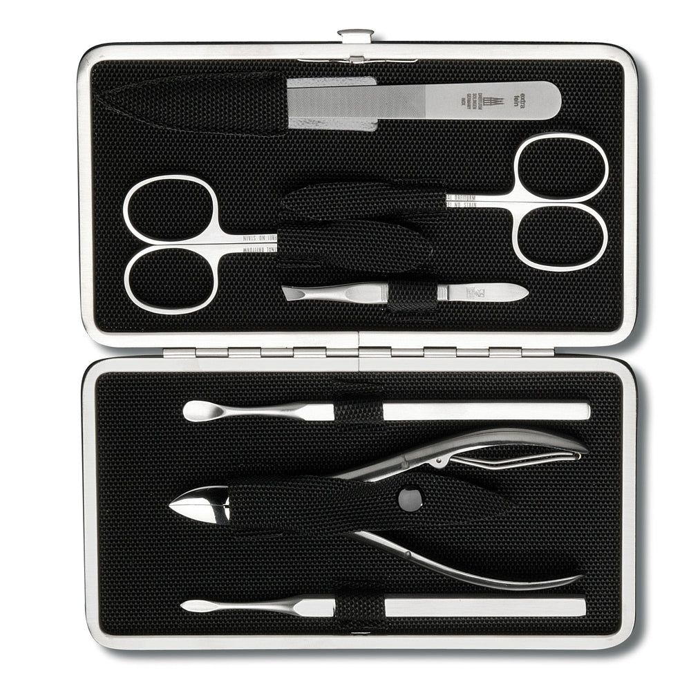 Maniküre-Etui mit silbernen Instrumenten: Nagelfeile, Schere, Pinzette, Nagelknipser und Hautschieber.