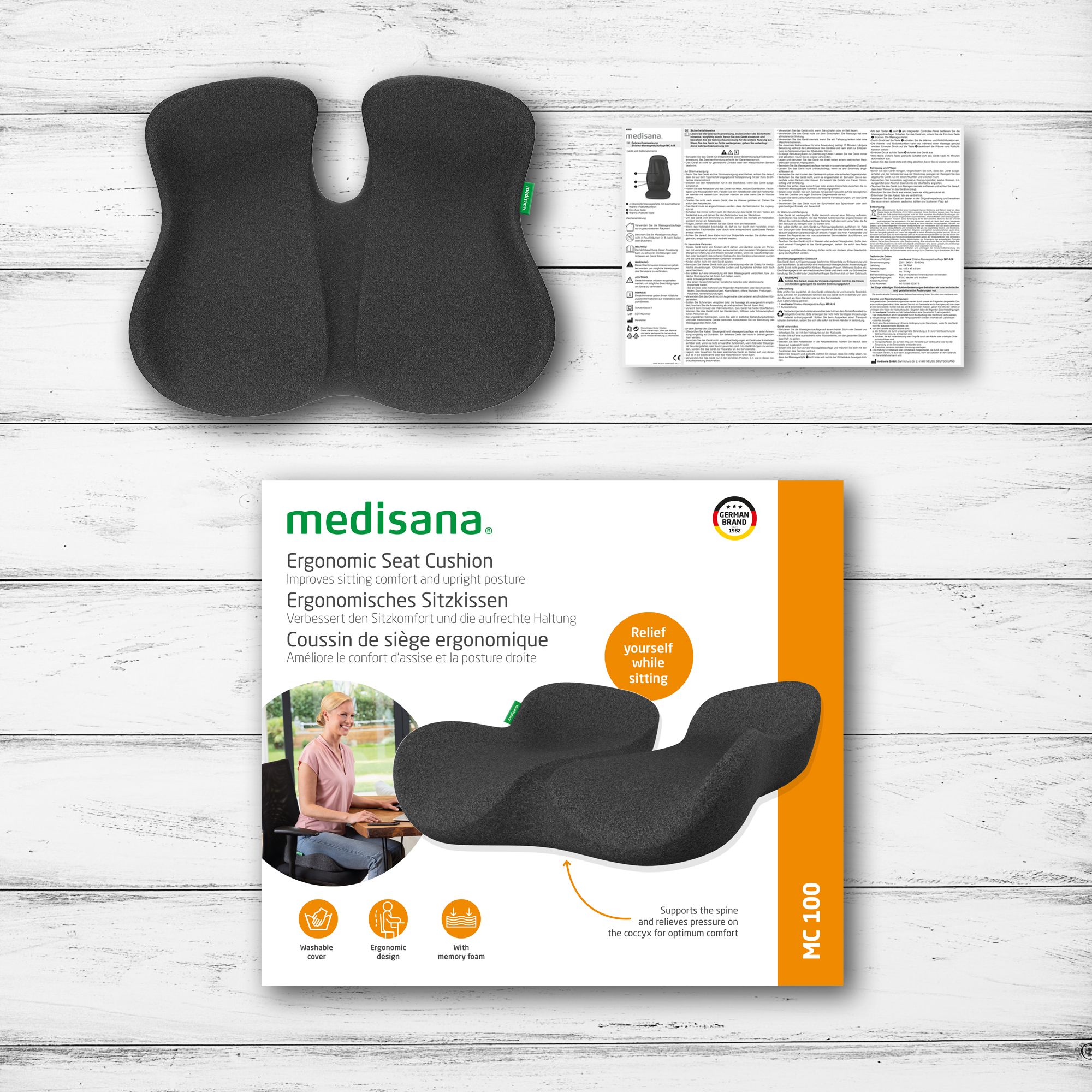Verpackung des ergonomischen Sitzkissens. Zeigt das Produkt und Informationen. Mit Text: Ergonomisches Sitzkissen.