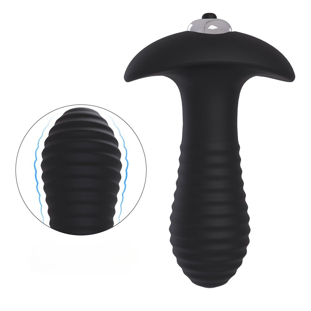 Schwarzer Analvibrator mit geriffelter Oberfläche. Vergrößerte Ansicht der Riffelung. Wellenlinien.