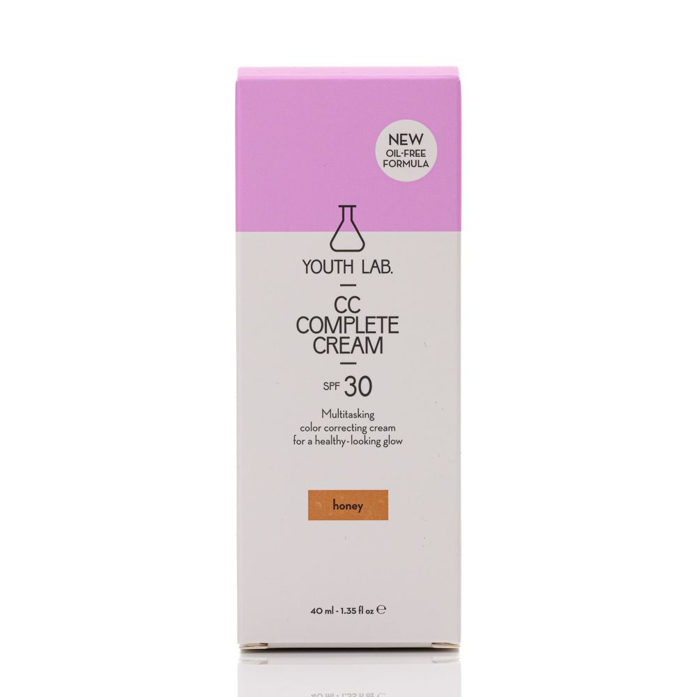 Verpackung von YOUTH LAB CC Complete Cream Honey. Weißer Karton mit rosa Akzenten. Text: CC Complete Cream, SPF 30, Honey. Mit Aufschrift "NEW OIL-FREE FORMULA".
