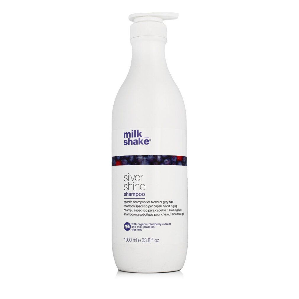 Weiße Flasche mit Pumpe. Aufschrift: milk_shake Silver Shine Shampoo. Blaue und rote Dekoration. 1000 ml.