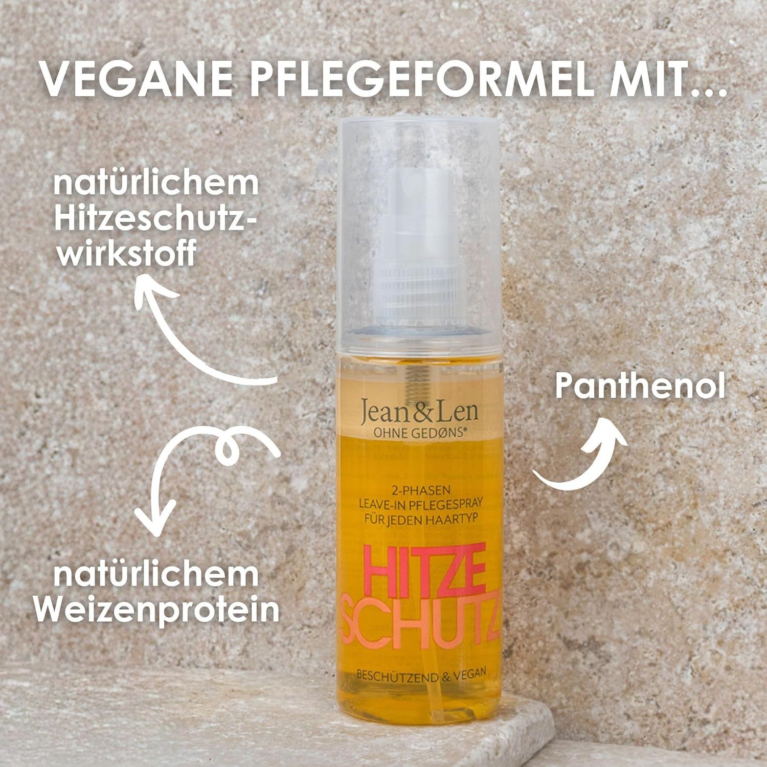 Transparente Sprühflasche mit gelber Flüssigkeit. Aufschrift: Jean & Len, Hitzeschutz. Pfeile zeigen auf Inhaltsstoffe: Weizenprotein, Hitzeschutz.