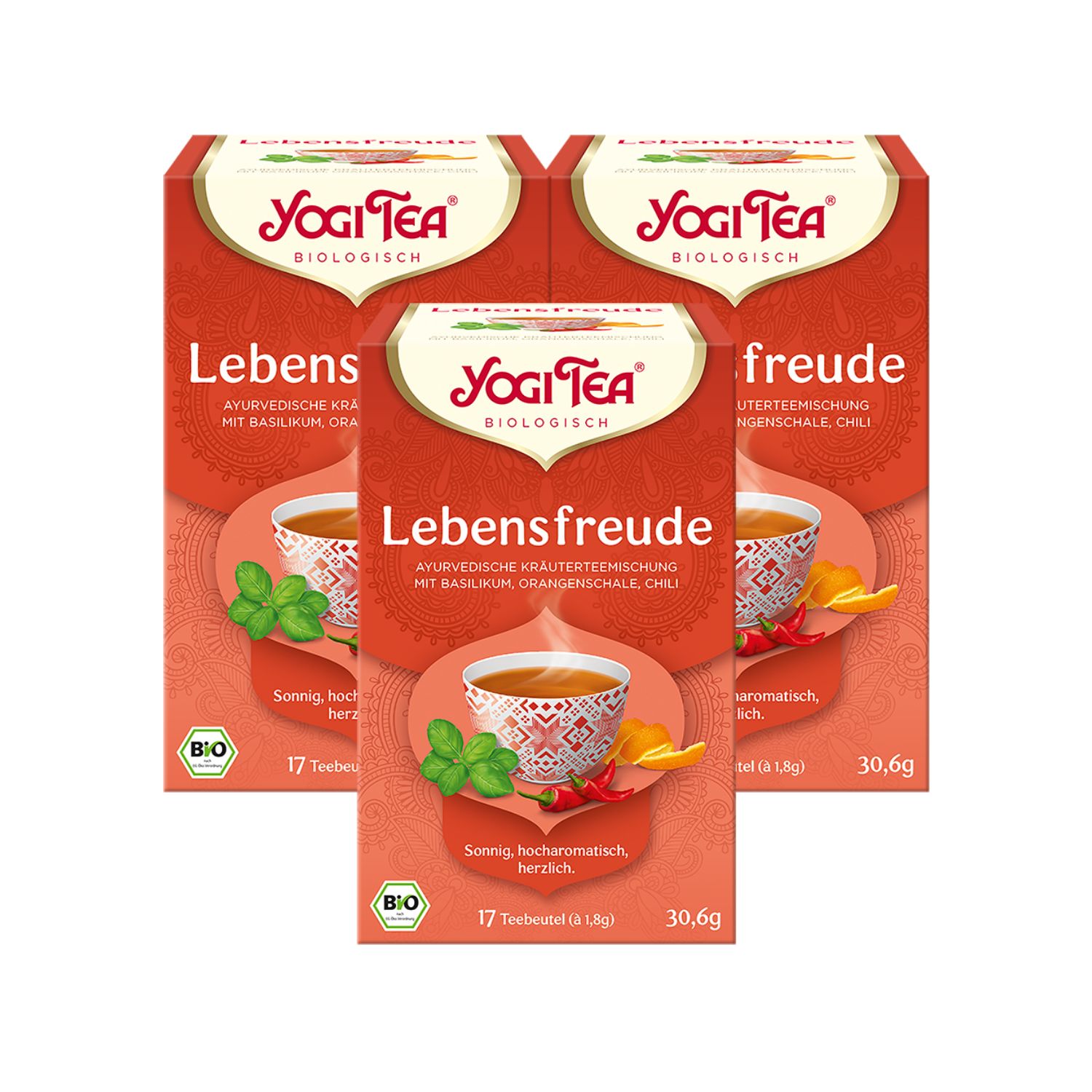 Drei Packungen Yogi Tea Lebensfreude. Rote Verpackung mit Logo und Produktinformationen. Bio-Siegel.