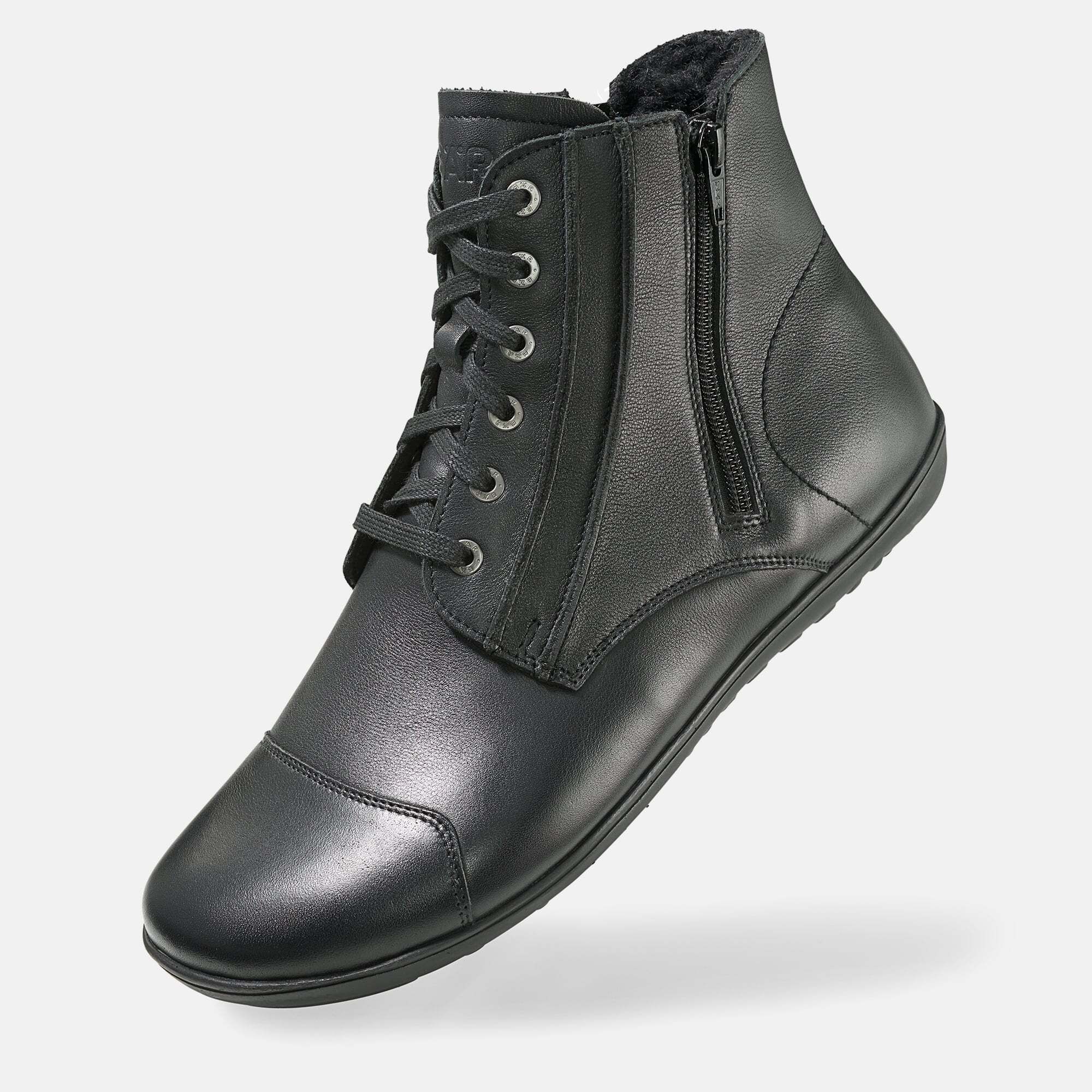 Schwarze Stiefelette mit Schnürung und Reißverschluss. Lederoptik, flache Sohle. Schuh von der Seite, leicht schräg.