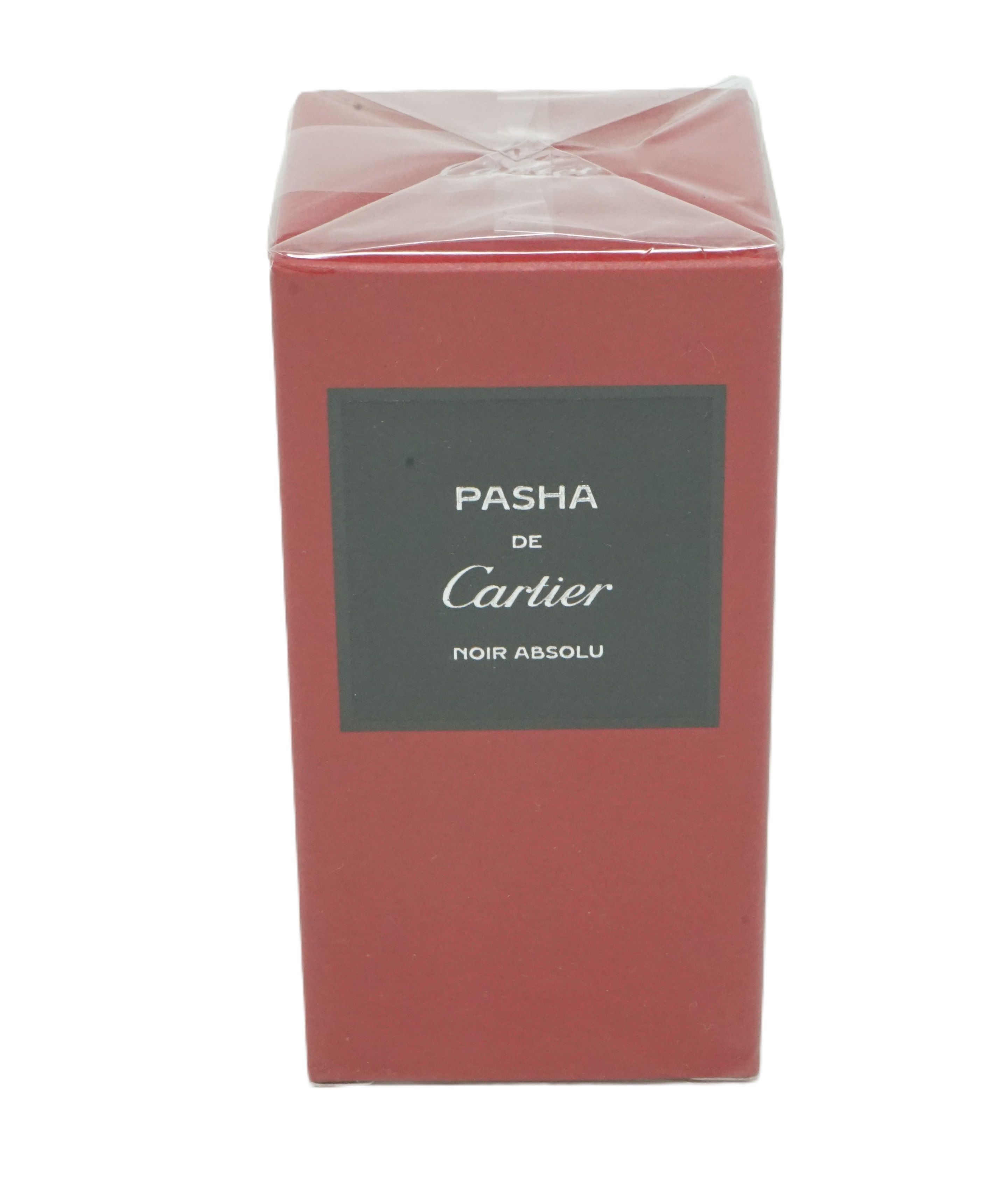 Rote rechteckige Verpackung mit schwarzem Etikett. Aufschrift: PASHA de Cartier Noir Absolu.