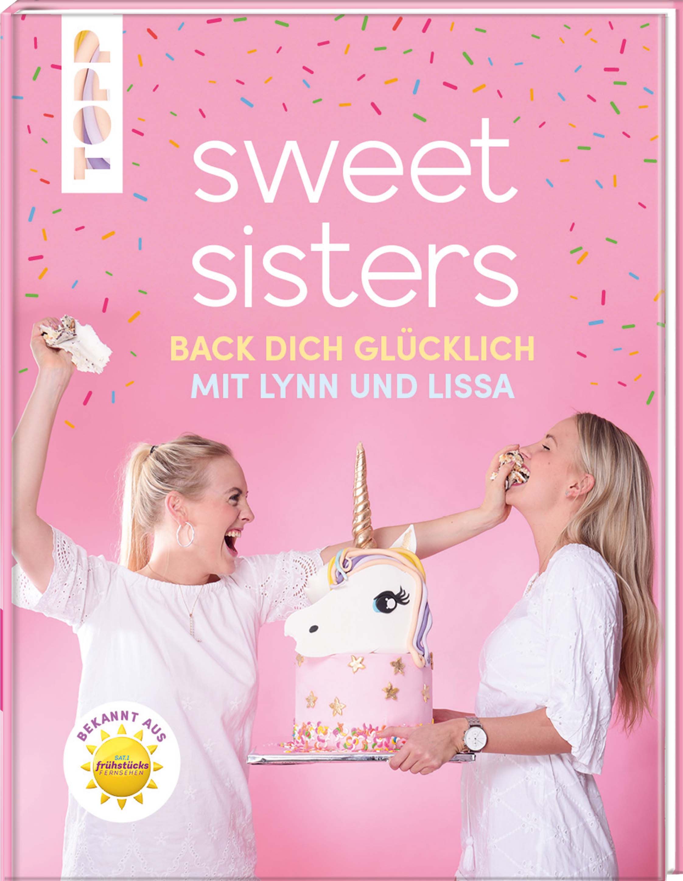 Buchcover mit Titel "Sweet Sisters". Zwei Frauen mit Einhorn-Torte. Aufkleber "Bekannt aus Frühstücksfernsehen". Rosa Hintergrund.