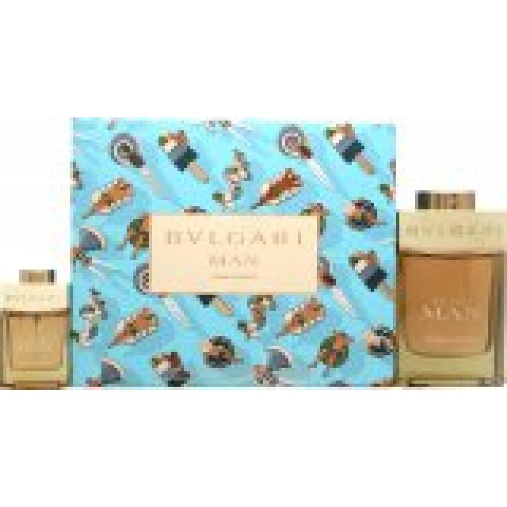 Geschenkset mit zwei Parfümflaschen. Rechteckige Flakons mit hellbrauner Flüssigkeit. Verpackung mit Sommer-Motiv und Schriftzug.