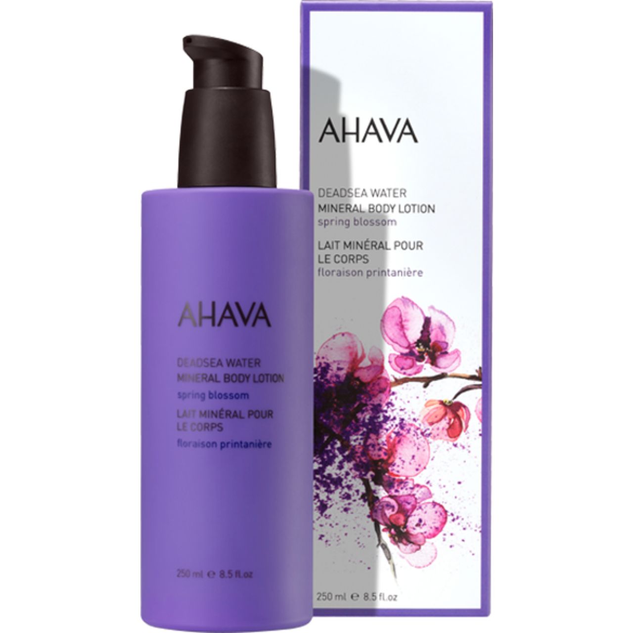 Lila Flasche mit schwarzem Pumpkopf und Verpackung. Text: AHAVA, DEADSEA WATER Mineral Body Lotion Spring Blossom. 250 ml.
