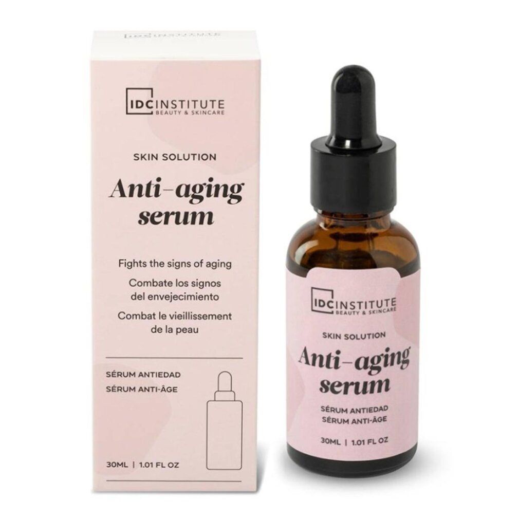 Produkt und Verpackung. Braune Flasche mit schwarzem Tropfer. Rosa Etikett mit Text: Anti-aging serum. Marke: IDC INSTITUTE.