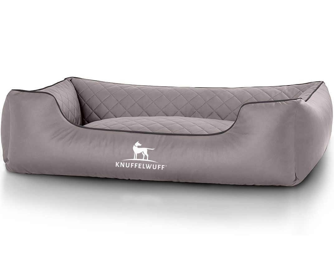 Graues orthopädisches Hundebett mit gesteppter Oberfläche und schwarzer Umrandung. Logo: Knuffelwuff.