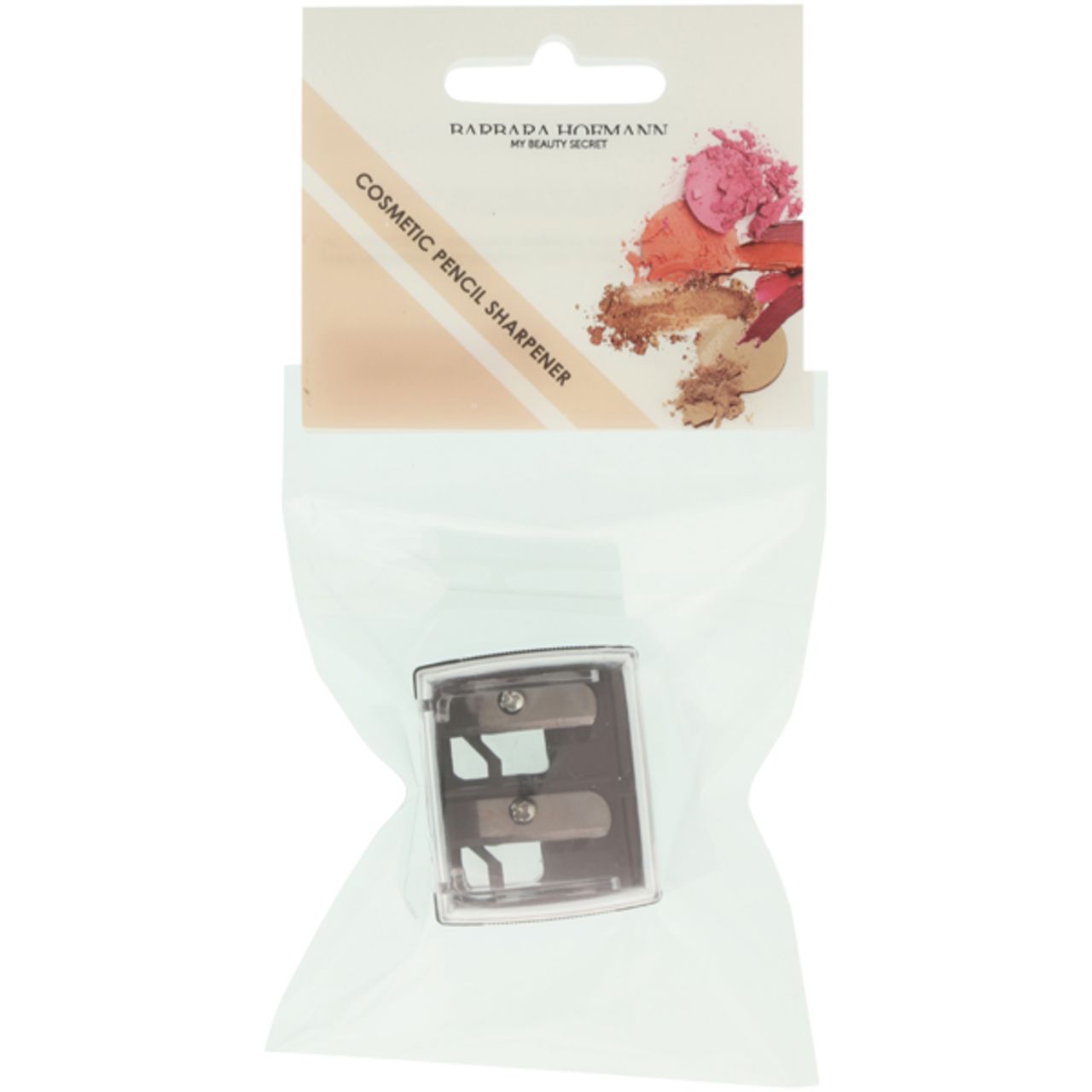 Kosmetikstiftspitzer in Plastikverpackung. Transparentes Gehäuse mit zwei Öffnungen und Klingen. Aufschrift: Barbara Hofmann, Cosmetic Pencil Sharpener.