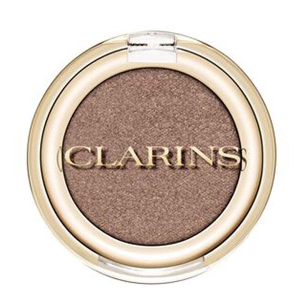 Runder Lidschatten-Compact mit goldfarbenem Rand und transparentem Deckel. Der Lidschatten ist taupefarben. Clarins-Logo.