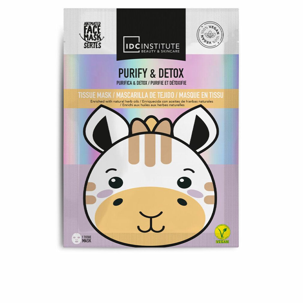 Gesichtsmaske mit Giraffen-Design. Verpackung mit Aufschrift 'Purify & Detox' und 'IDC Institute'. Vegan-Siegel.