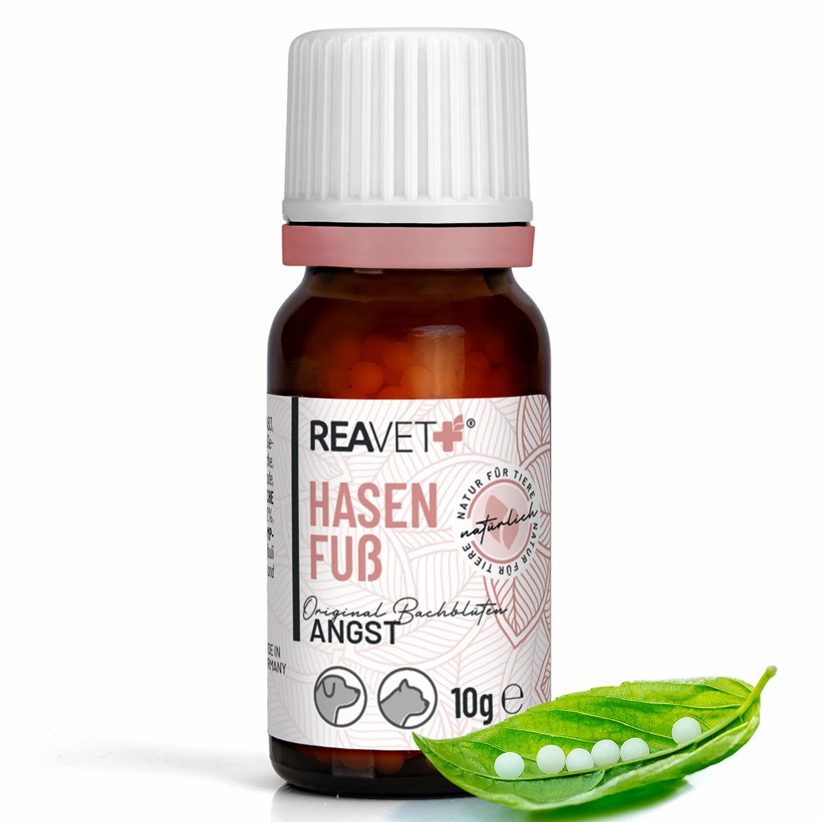 Braune Glasflasche mit weißem Schraubverschluss, gefüllt mit Globuli. Daneben eine grüne Hülse mit fünf Globuli.