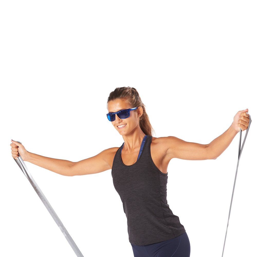 Frau mit blauer Brille und Sportkleidung. Sie hält ein Theraband in den Händen.