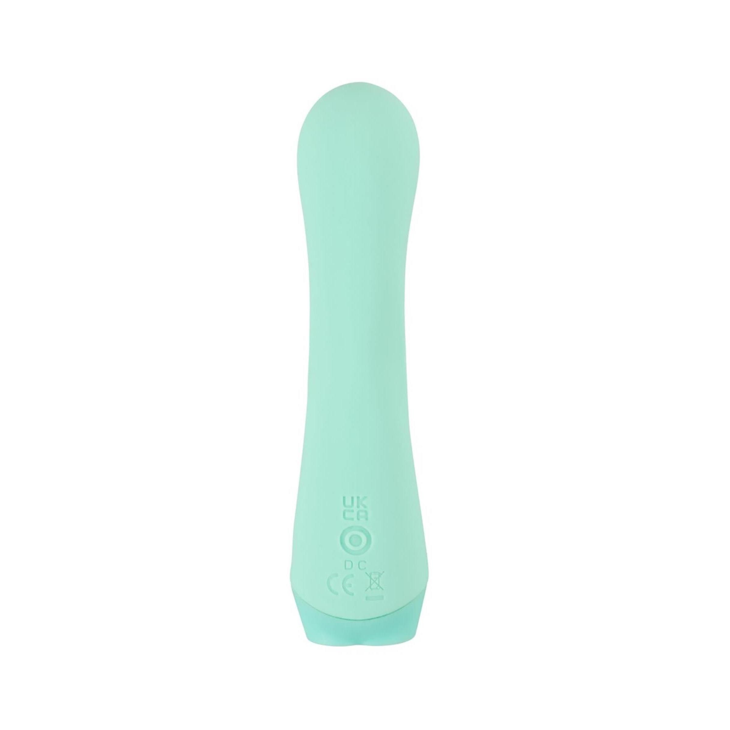 Mintgrüner Minivibrator. Zylindrische Form mit abgerundeten Enden. Auf der Unterseite befinden sich Markierungen.
