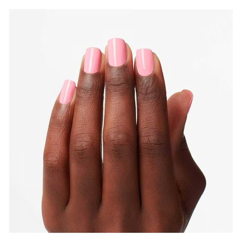 Hand mit lackierten Nägeln. Die Nägel sind mit rosa Nagellack lackiert.