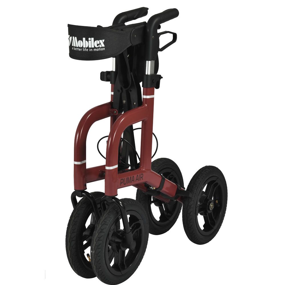 Zusammengeklappter Rollator Puma Air, rot. Vier Räder, schwarze Reifen. Sitzfläche, Rückenlehne, Handgriffe. "PUMA AIR" Schriftzug.