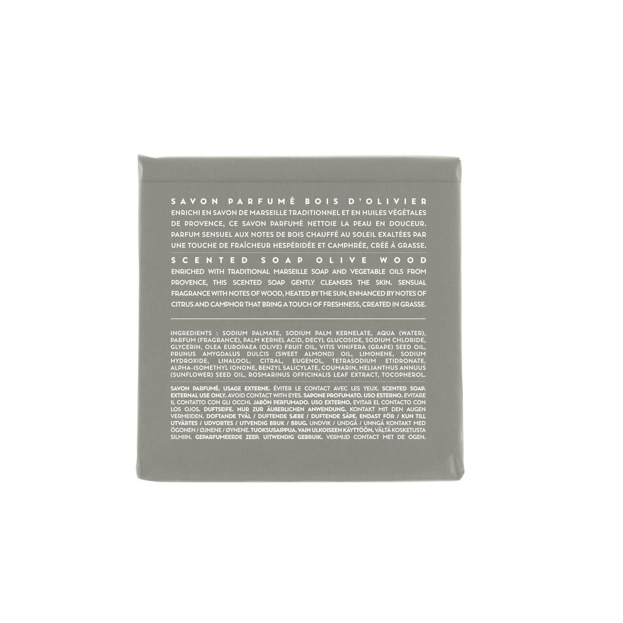 Graues Seifenstück mit Text. Text: Savon Parfume Bois d'Olivier. Inhaltsstoffe und Beschreibung auf Englisch und Französisch.