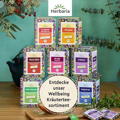 Herbaria Kräuterteesortiment: Mehrere Packungen mit floralem Design, Teebeutel.