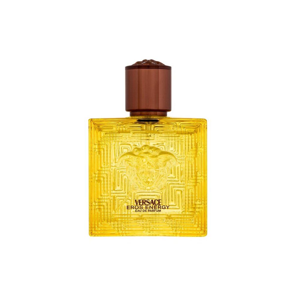 Gelber Flakon Versace Eros Energy. Brauner Verschluss. Quadratische Form mit Reliefmuster. Versace-Logo sichtbar.