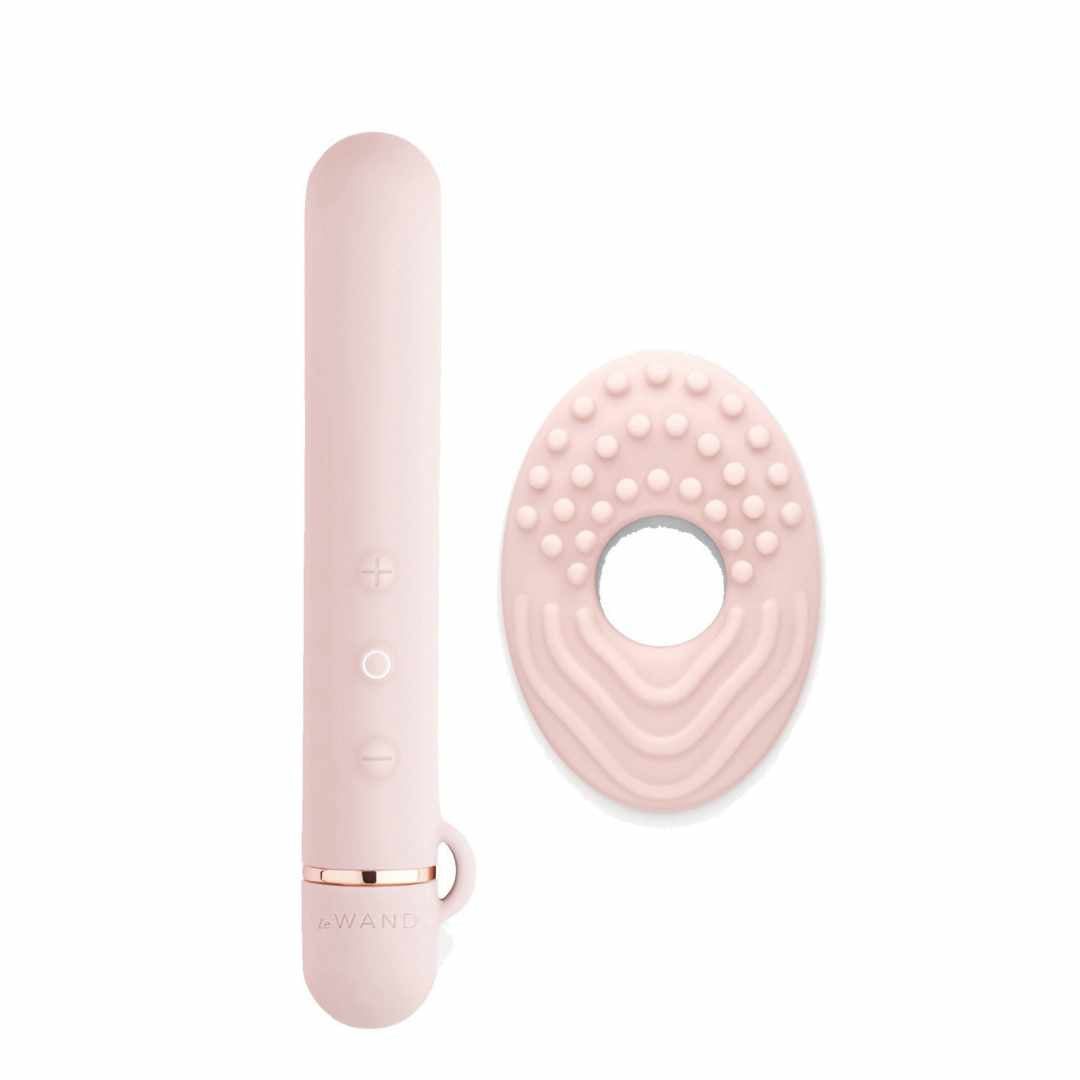 Rosa Stab-Vibrator und Ring-Aufsatz. Der Stab hat Knöpfe und einen Ring. Der Ring hat Noppen und Rillen.