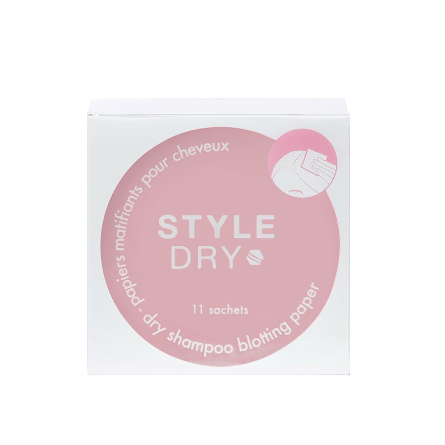 Scatola quadrata di carta assorbente per shampoo secco STYLEDRY. Il nome del marchio e il nome del prodotto sono su un cerchio rosa. È visibile anche il testo '11 sachets'. Lo sfondo è bianco.