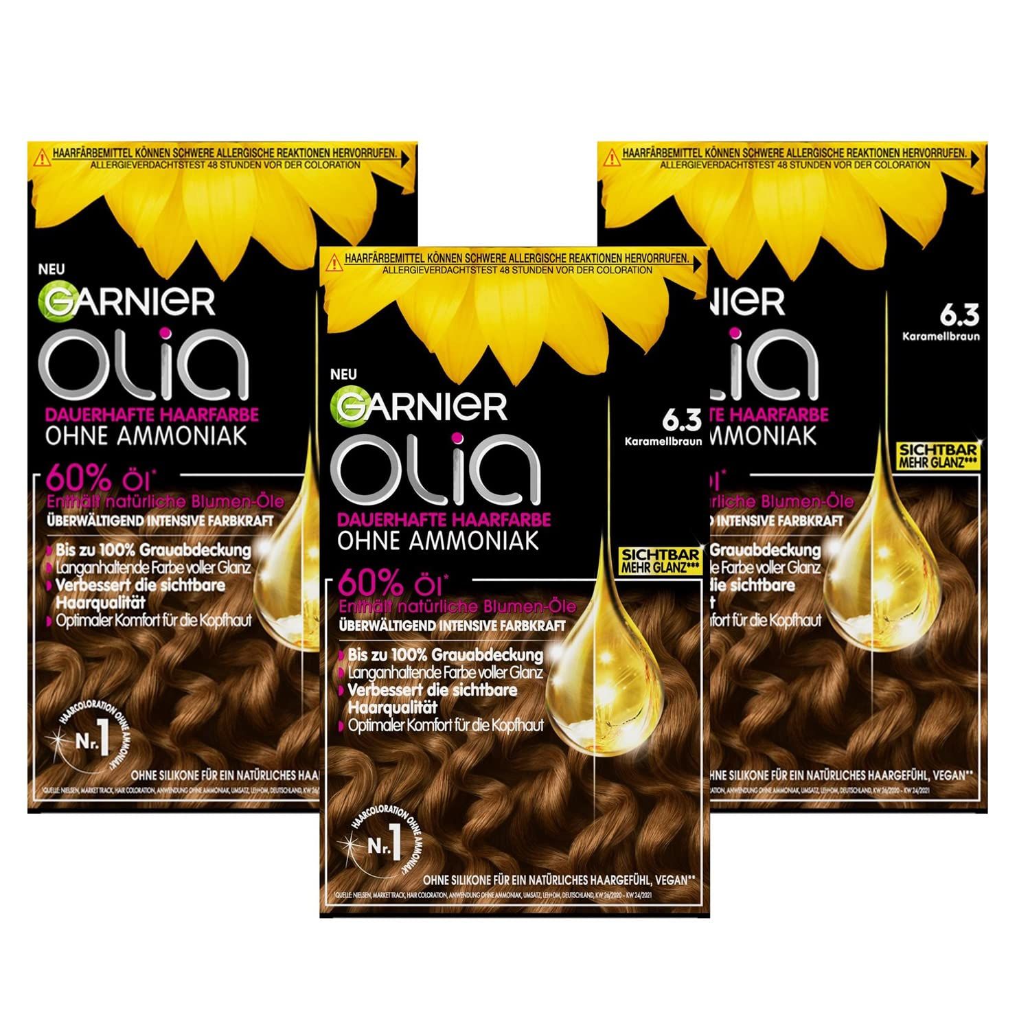 Drei Packungen Garnier Olia Haarfarbe. Aufdrucke: 6.3 Karamellbraun, ohne Ammoniak, 60% Öl, vegan.