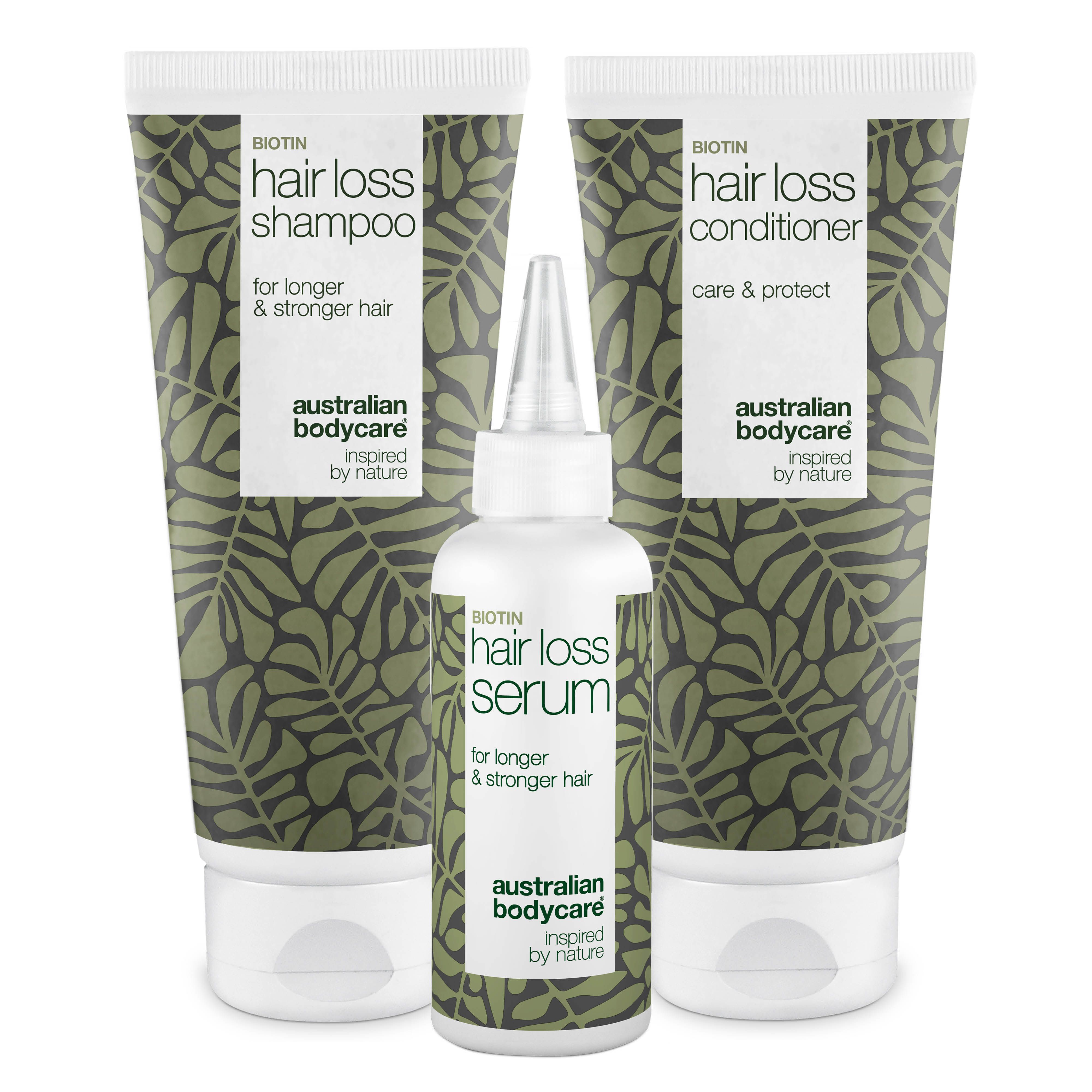 Drei Produkte: Shampoo, Conditioner und Serum. Alle in weißen Tuben und Flaschen mit grünen Blättern und Text.