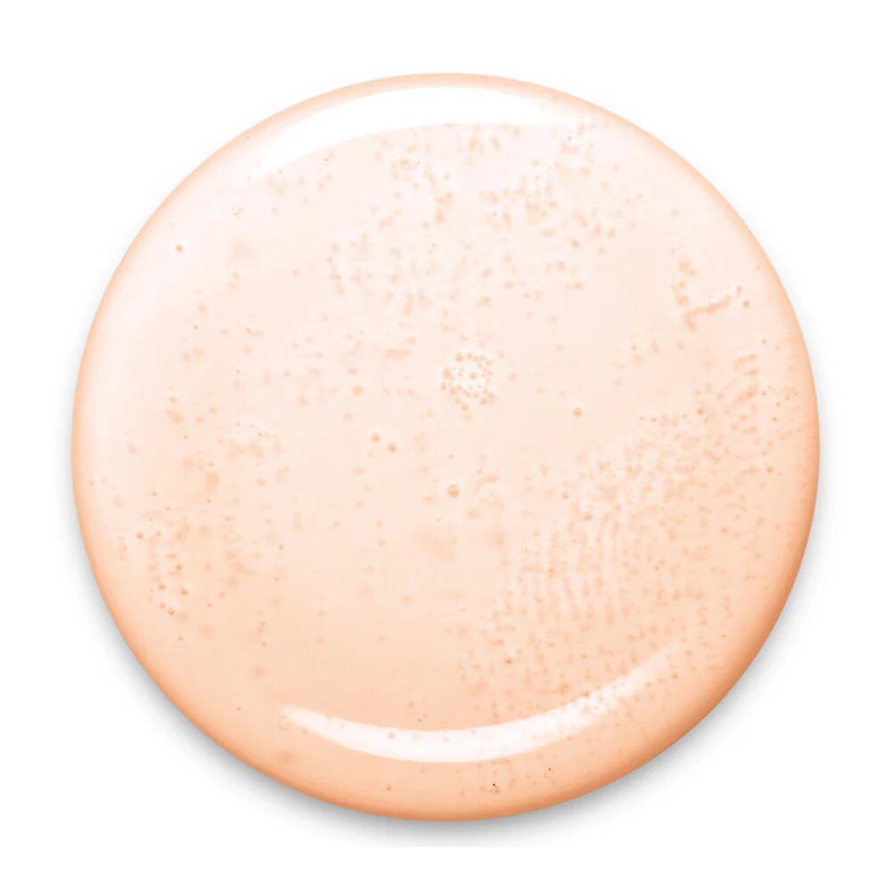 Runder, hellrosa Nagellack-Fleck. Die Oberfläche ist glänzend und weist leichte Unregelmäßigkeiten auf.