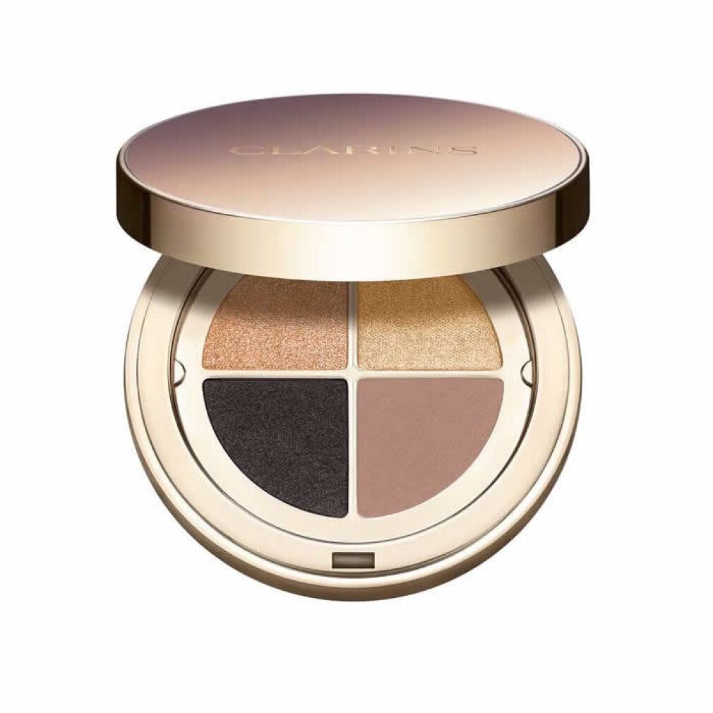 Runde Lidschatten-Palette mit vier Farben. Deckel geöffnet. Farben: Gold, Braun, Schwarz und Rosa. Goldfarbener Rahmen.
