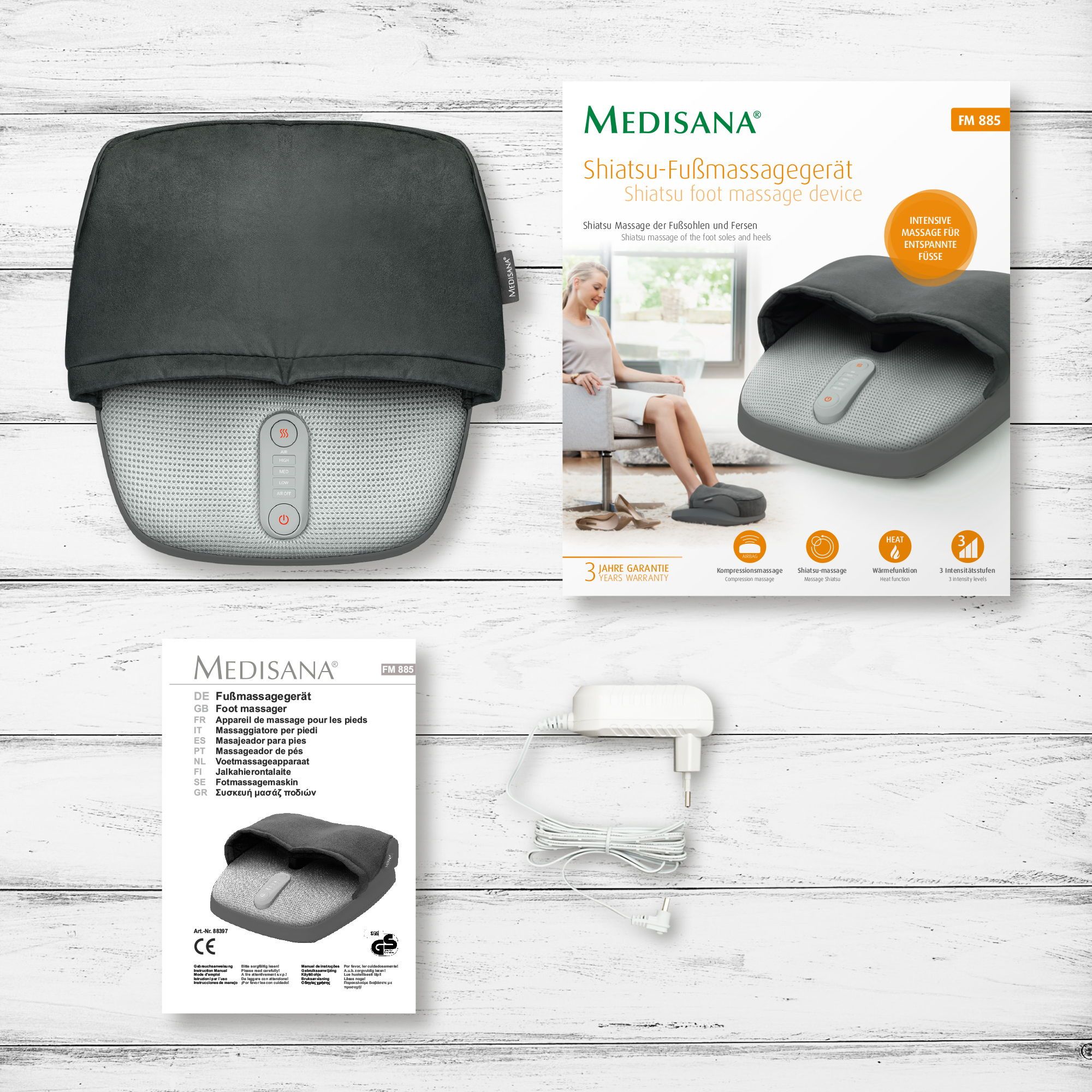 Shiatsu-Fußmassagegerät mit Verpackung, Anleitung und Netzteil.