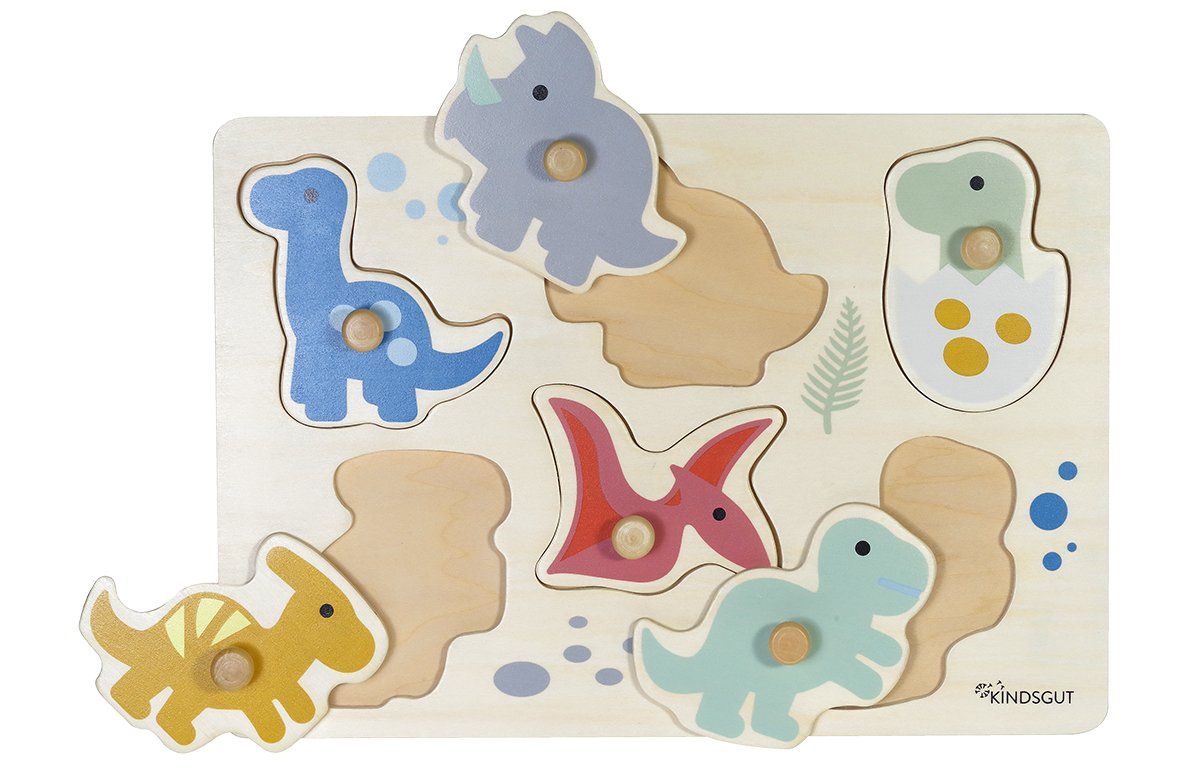 Holzpuzzle mit sechs Dinosauriern, drei Puzzleteile sind entfernt. Knöpfe an den Teilen. Kindsgut-Logo unten rechts.