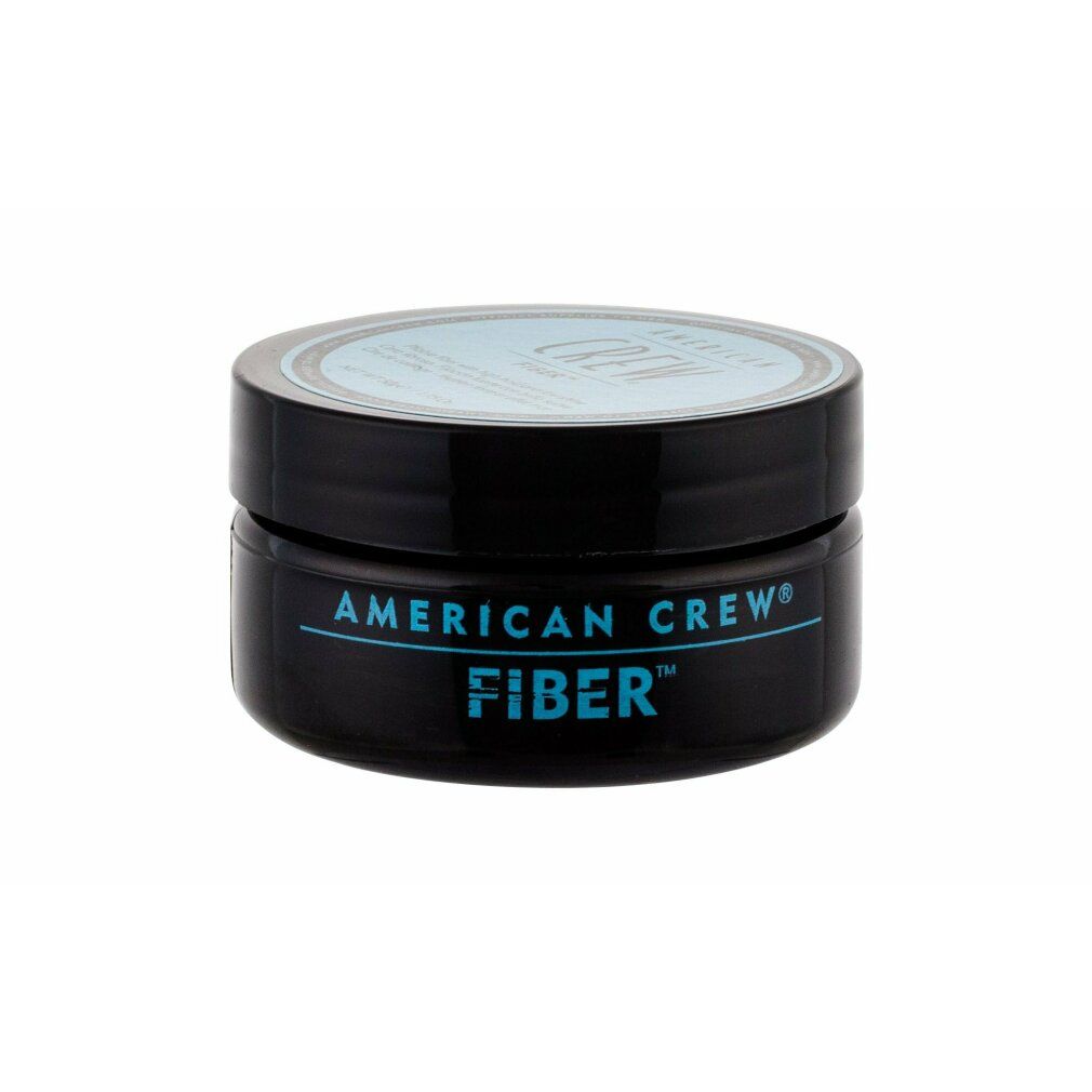 Schwarzer Tiegel mit blauem Deckel. Aufschrift: AMERICAN CREW FIBER. Produkt für Haare.