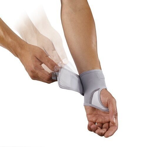 Person befestigt graue Handgelenkbandage. Klettverschluss wird geschlossen. Push-Braces-Logo sichtbar.