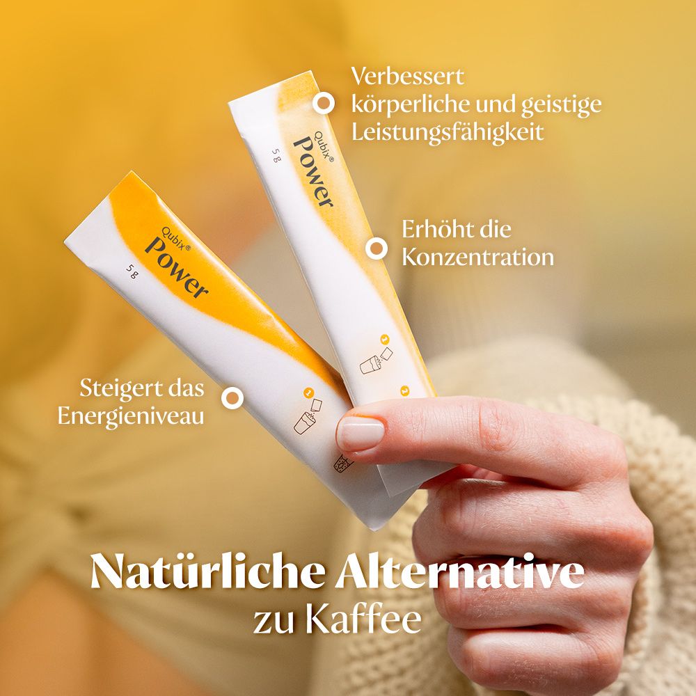 Zwei Beutel Qubix Power. Weiß-gelbe Verpackung. Aufschrift Power. In einer Hand gehalten.