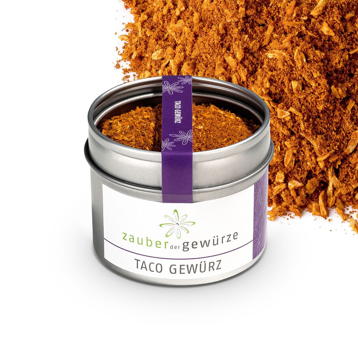 Geöffnete Dose mit Taco Gewürz. Aufschrift: Zauber der Gewürze, Taco Gewürz. Lila Band mit Text.